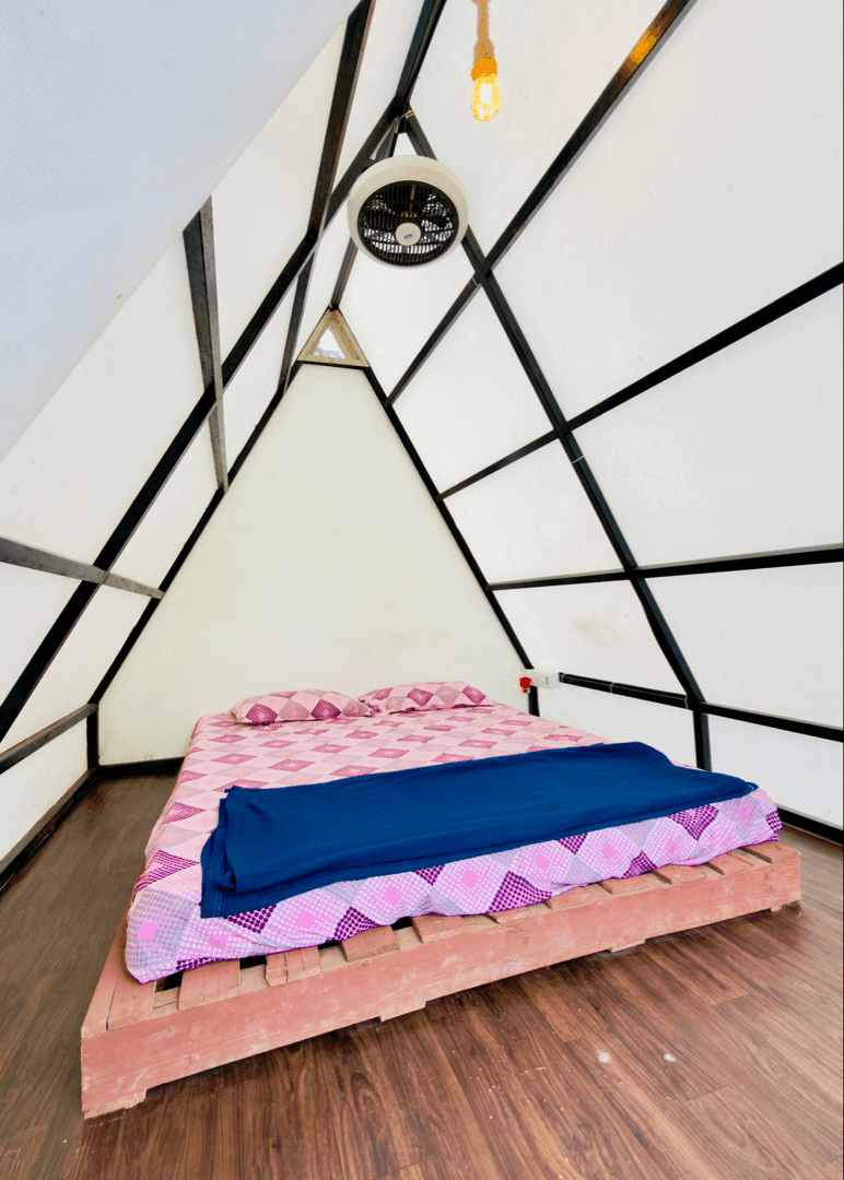 Glamping triangle interior with queen bed
